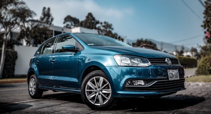 A blue Volkswagen is parked on the street, which RED Shield Administration can protect